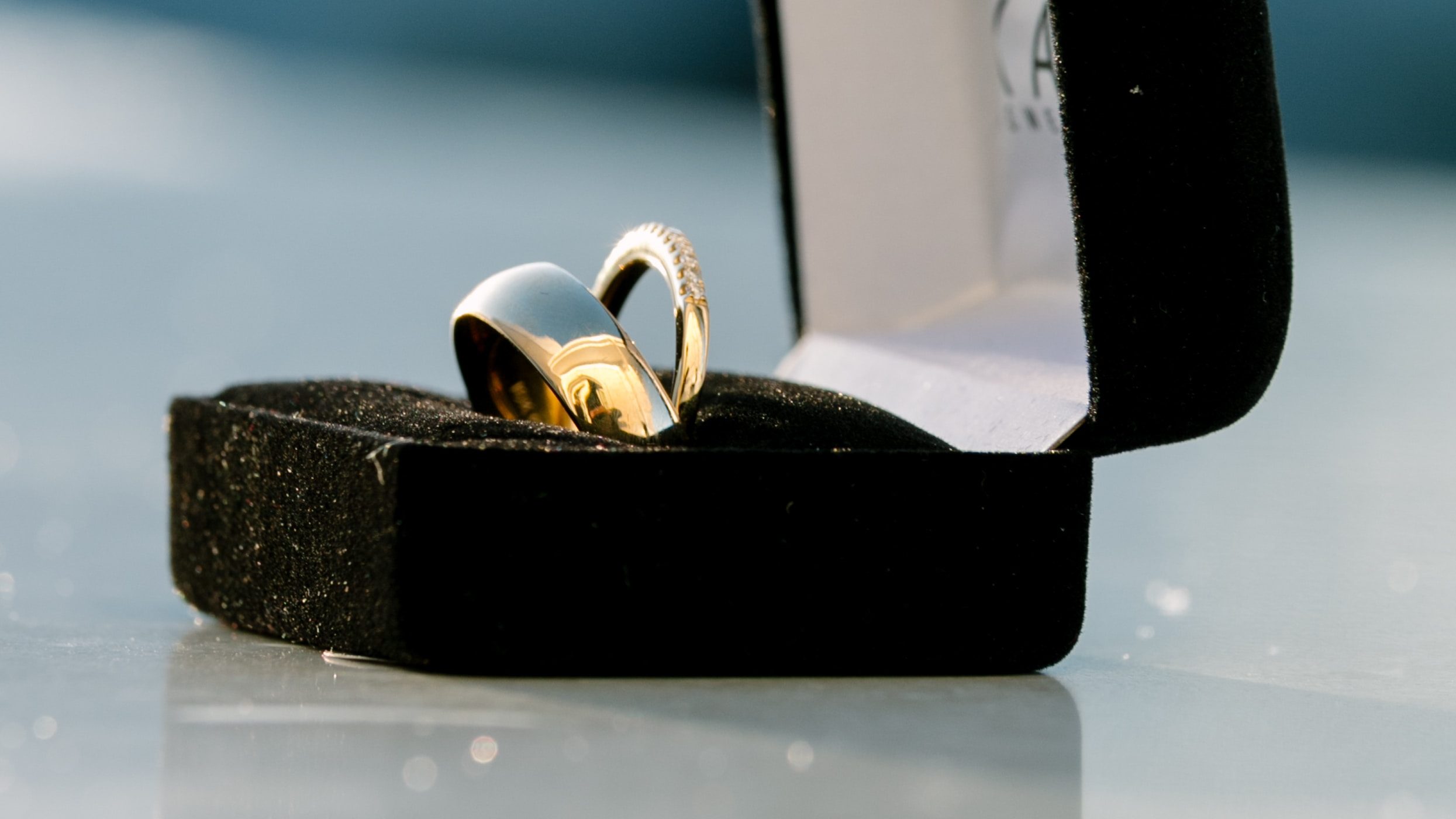 Silver-colored bridal ring set on box on top of white surface photo