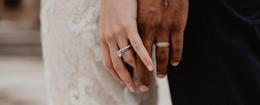 Husband and Wife Holding Hands with Wedding Bands On